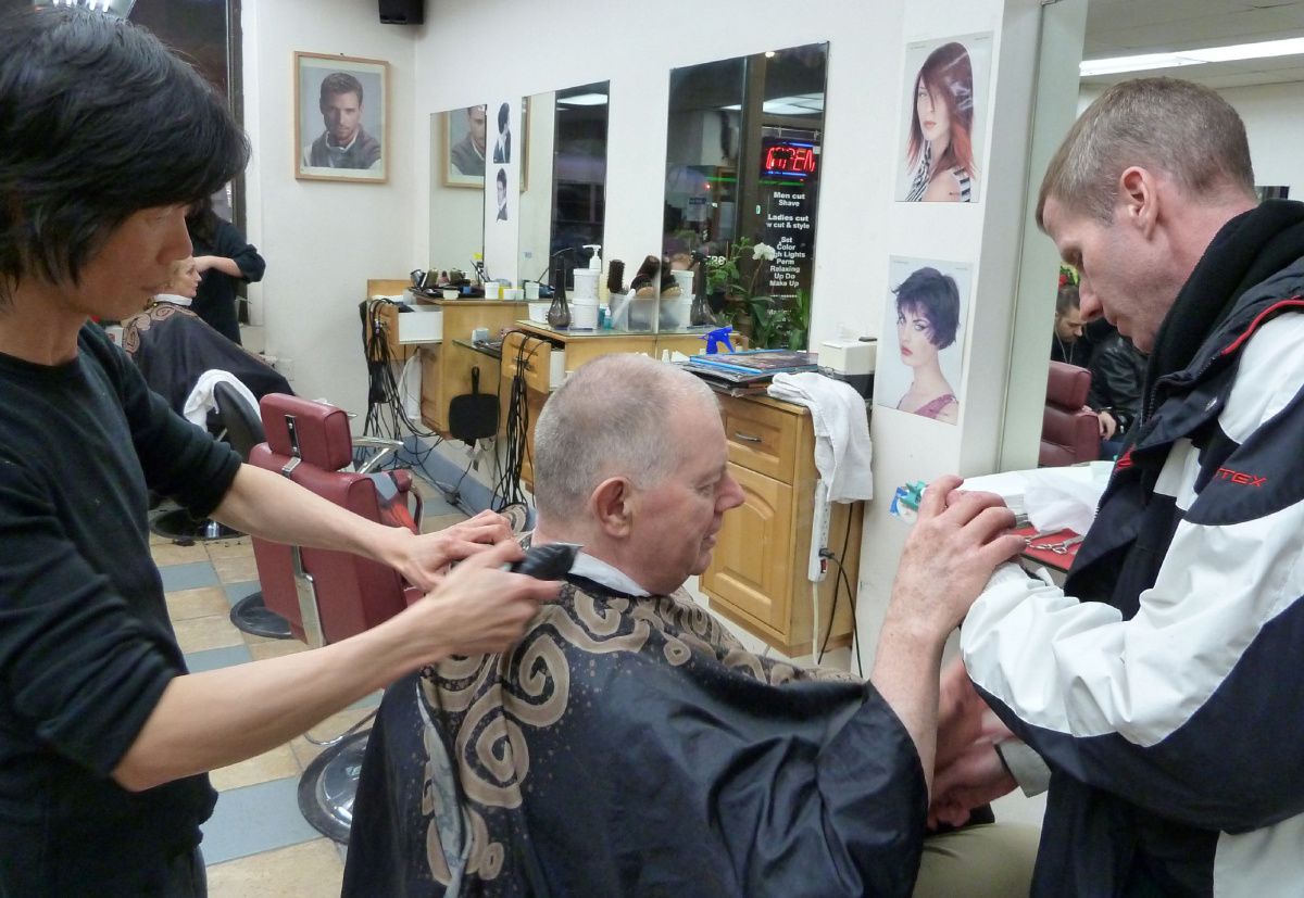 Cyril Cassell getting his hair cut