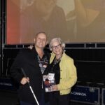 Author of Deafblind Champion, Kevin Frost poses with his book with CanPlan conference planner, Bettyanne Sherrer.